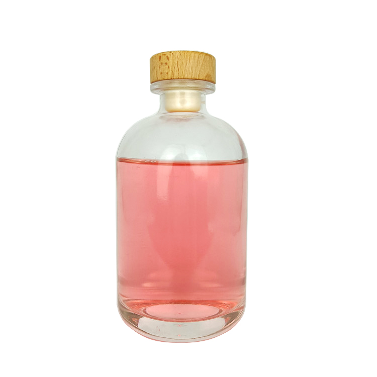 Wholesale 500ml round clear glass bottle for beverage with cork