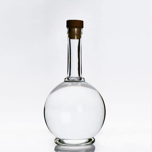 Factory wholesale 700ml gin glass bottle round shape vodka liquor bottle with cork custom logo whisky glass bottle